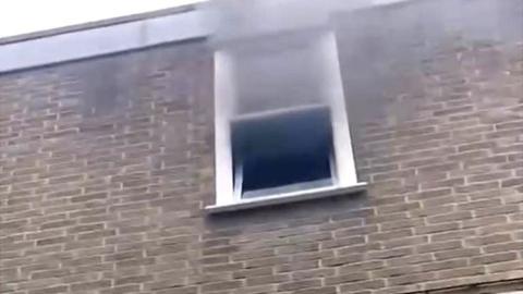 Smoke coming out of a window at the school