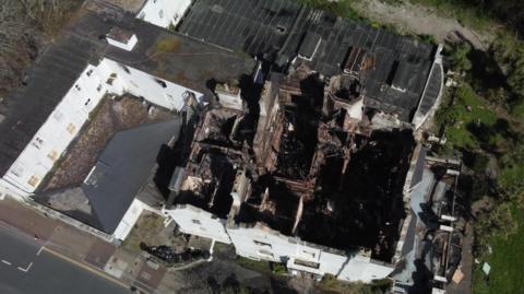 An ariel view of the former Sherwood Hotel. The roof is burnt.