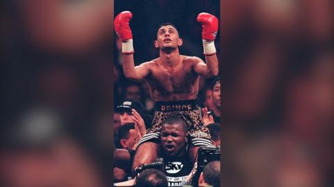 Prince Naseem Hamed, boxing world featherweight champion, is lifted high above the crowd in 1997