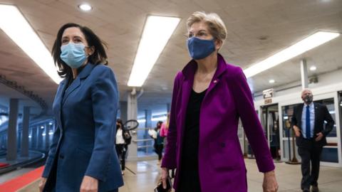 Democratic Senator from Washington Maria Cantwell (L) and Democratic Senator from Massachusetts Elizabeth Warren (R) walk to the Senate chamber as the Senate meets, 5 March