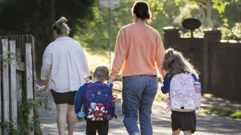 Parents and children walking to school