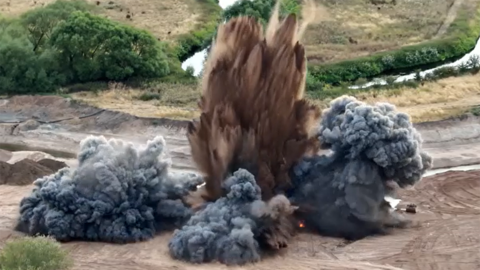 Close up of bomb being blown up in quarry