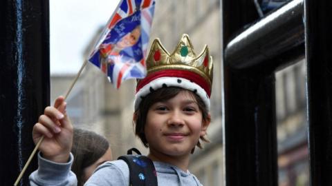 A well-wisher outside St Giles' Cathedral, Edinburgh, ahead of the National Service of Thanksgiving and Dedication for King Charles III and Queen Camilla, and the presentation of the Honours of Scotland