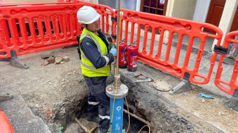 An engineer doing maintenance work on a gas pipe