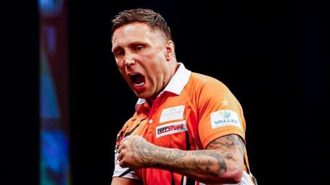 Gerwyn Price pumps his fist in celebration at the Premier League of Darts in Rotterdam