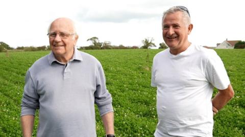 Reg Mead and Richard Miles in a field