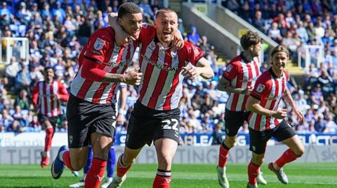 Ryan One of Lincoln City, left, celebrates scoring the opening goal with team-mate Tom Hamer