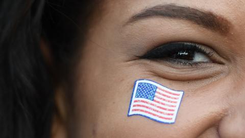 A woman with a US flag sticker on her face