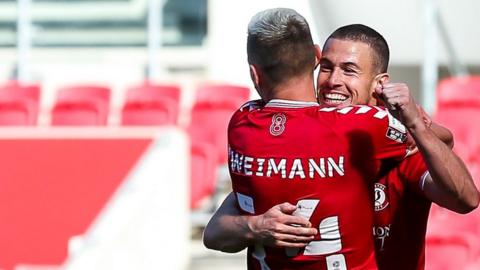 Andreas Weimann celebrates with Tommy Rowe after Rowe scores for Bristol City against Sheffield Wednesday