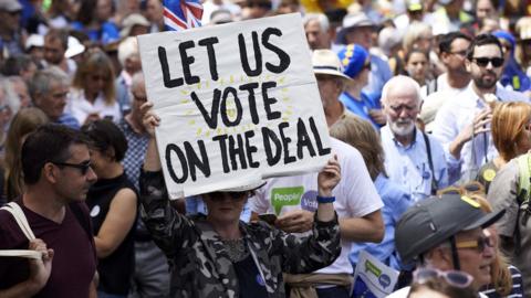 demonstrators carry banners and flags as they participate in the People"s March demanding a People"s Vote on the final Brexit deal, in central London on the second anniversary of the 2016 referendum.