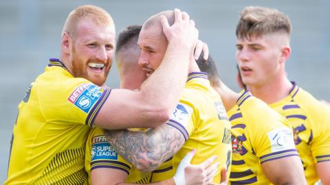 Wigan celebrate a try against Wakefield