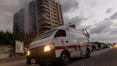 An ambulance at an apartment hit by an Israeli airstrike in Beirut. Lebanese healthcare officials say ambulances and hospitals have been hit by direct Israeli airstrikes.  