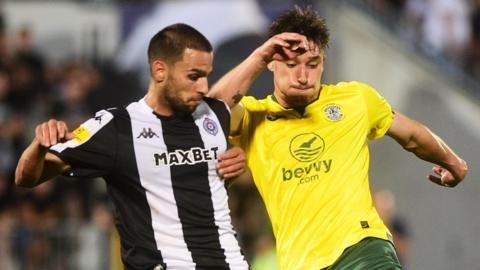 Partizan Belgrade's Nemanja Trifunovic and Hibernian's Kieron Bowie