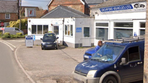 A photo of Urchfont Vehicles in the village, with two vehicles parked outside.