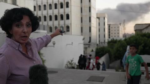 BBC World Service correspondent, Nafiseh Kohnavard pointing at smoke above Beirut