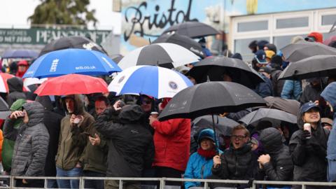 Fans shield under umbrellas during the fifth England-Australia ODI in Bristol