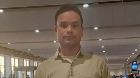 Masood Alam, one of the seafarers who returned on 29 March, wearing a tee shirt, pose for a photo.