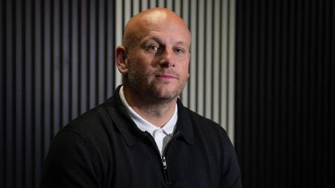 New Barrow manager Adam Murray sits preparing for an interview