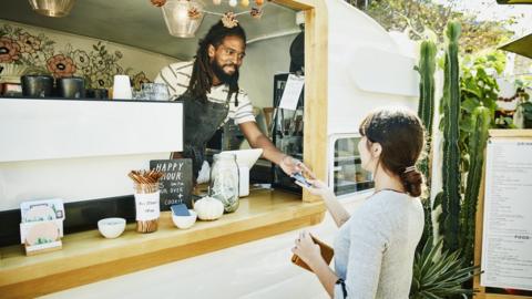 Food truck owner takes card payment from customer