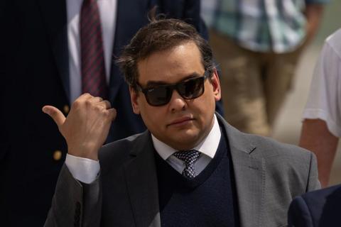 George Santos in a suit and wearing sunglasses