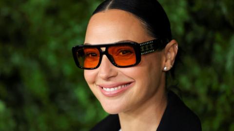 Gal Gadot smiling and wearing designer shades arriving at the Academy Women's Luncheon at the Academy Museum of Motion Pictures in Los Angeles on 10 December 2024