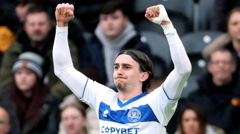 Daniel Bennie celebrates his goal by holding both arms aloft