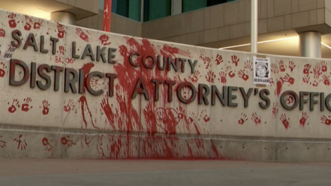 the district attorney's office sign with red paint on it