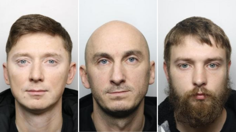 Custody pictures of three men, shown side by side. Each man faces forward against a plain, light background. The first has short brown hair and wears a black jacket; the second is bald with stubble and wears a dark top; the third has brown hair, a full beard, and wears a two-toned garment.