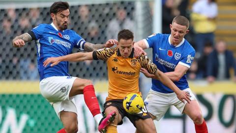 Portsmouth's Marlon Pack and Colby Bishop close down Hull's Amir Hadziahmetovic