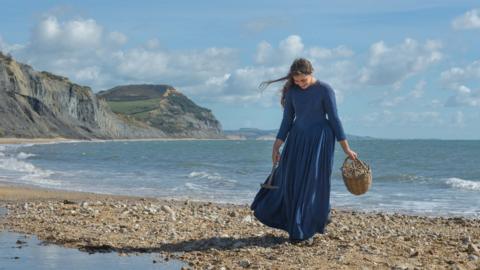 Katy Hamilton in costume as Mary Anning on the beach