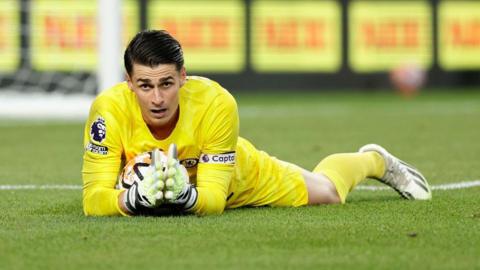 Kepa Arrizabalaga holds onto ball on grass for Chelsea