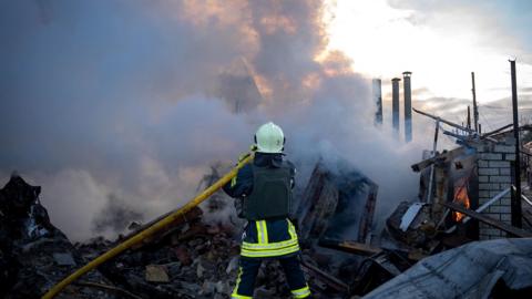 A firefighter works at the site of a residential area damaged by a Russian missile strike in Odesa