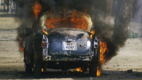 A car on fire during riots in the wake of Indira Gandhi's assasination
