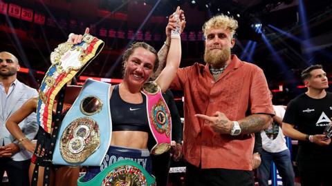 Jake Paul raises Ellie Scotney's hand