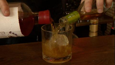 Seaweed infused rum being poured into glass