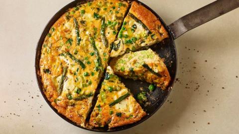 spring frittata baked in a pan on a beige background