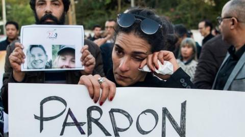 Moroccans attend a vigil for the murdered tourists