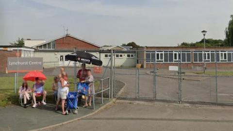 Google Maps image of the closed Lyndhurst Centre in Park North with people waiting outside the gates