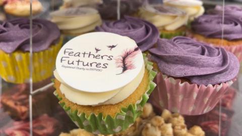 Cupcakes on a cake stand with the Futures Feathers logo