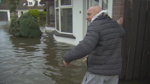 Nigel Richardson going into his flooded home in Portadown