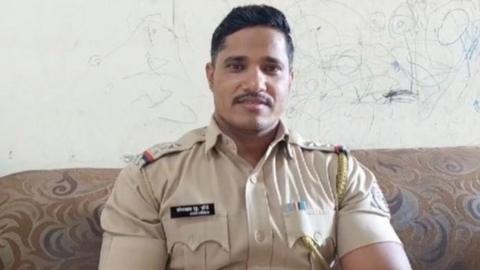 Somnath Zende seen in his police uniform at his home