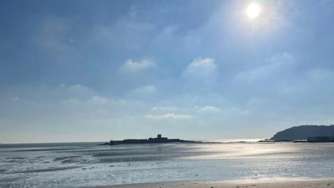 St Aubin's fort in the distance on a sunny day on low tide