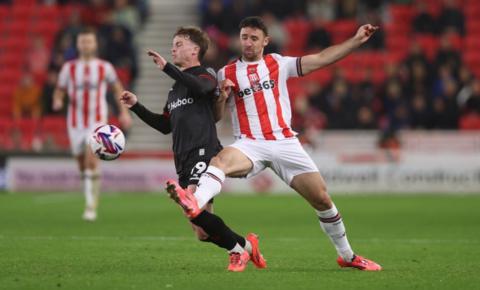 Stoke defender tackling Bristol's George Tanner