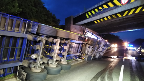 A lorry on its side on the A5 after hitting the Watling Street bridge in June 2022.
