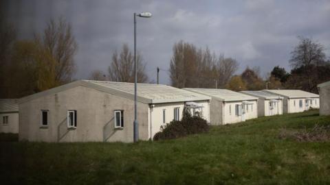 White, low, concrete outbuildings at Northeye