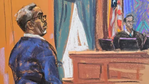 A court sketch of Sean "Diddy" Combs stands wearing glasses before U.S. District Judge Arun Subramanian as jury selection got underway at the start of his sex trafficking trial in New York City