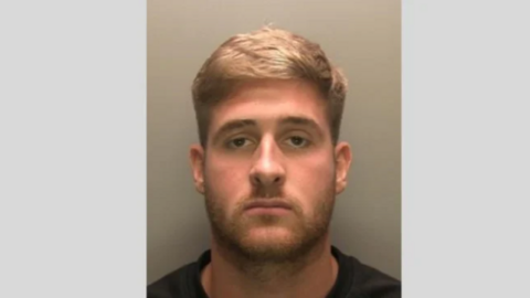 A mug shot of Jayden Deaken. He has stubble and blonde short hair.