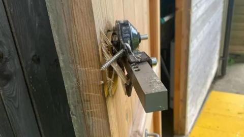 The lock which has been broken on the food bank door