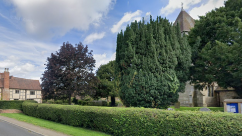 Bushes in front of church and nearby house