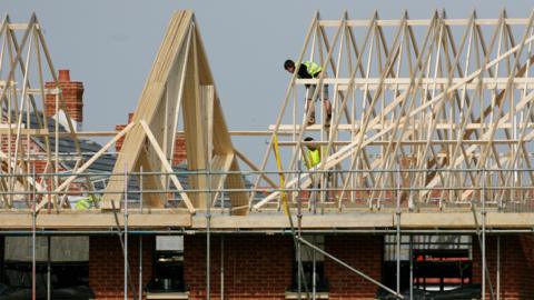 Builders working on a house